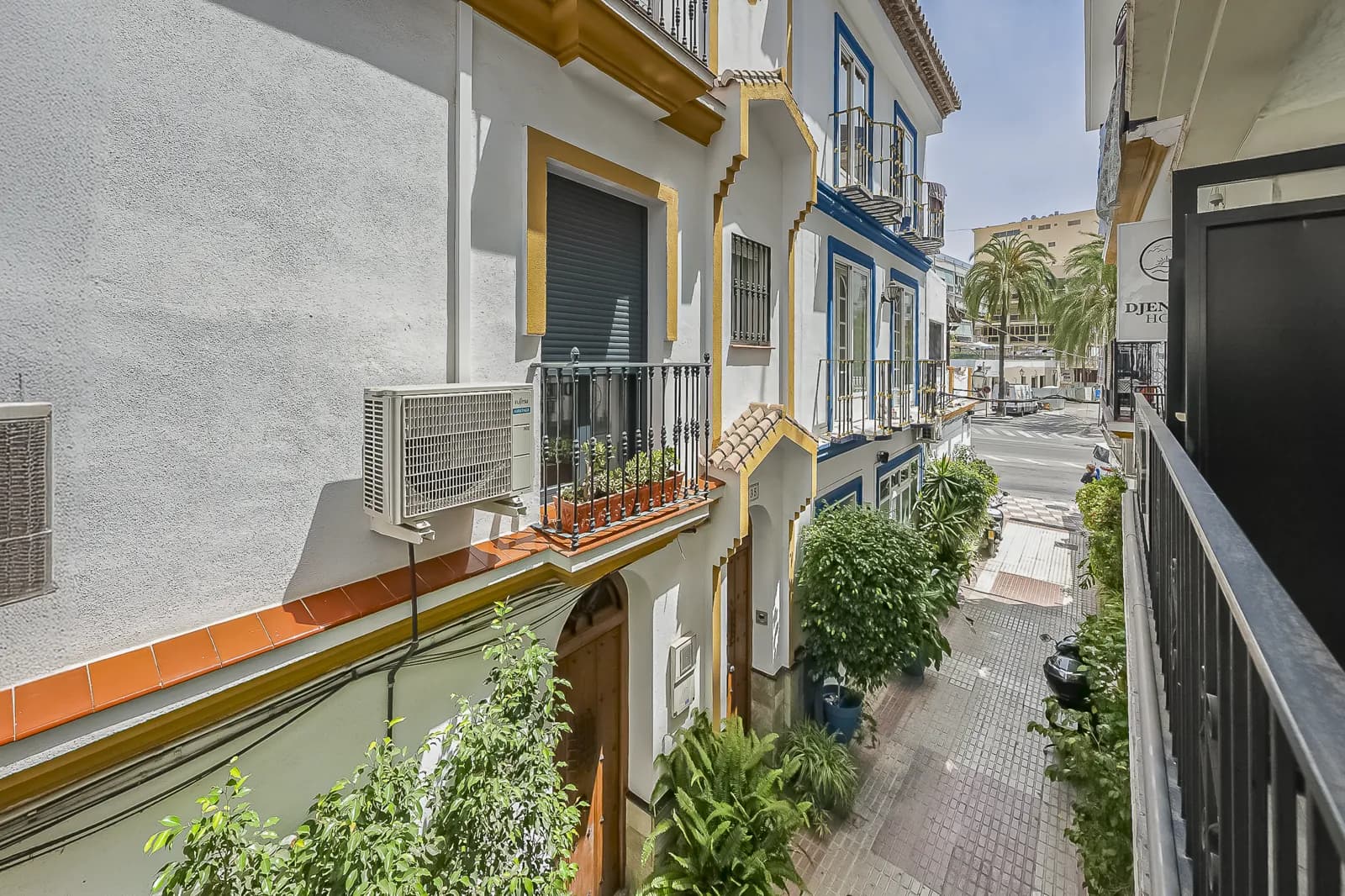 The view from Room 1: a Juliet balcony over the white houses and wrought iron of the old town