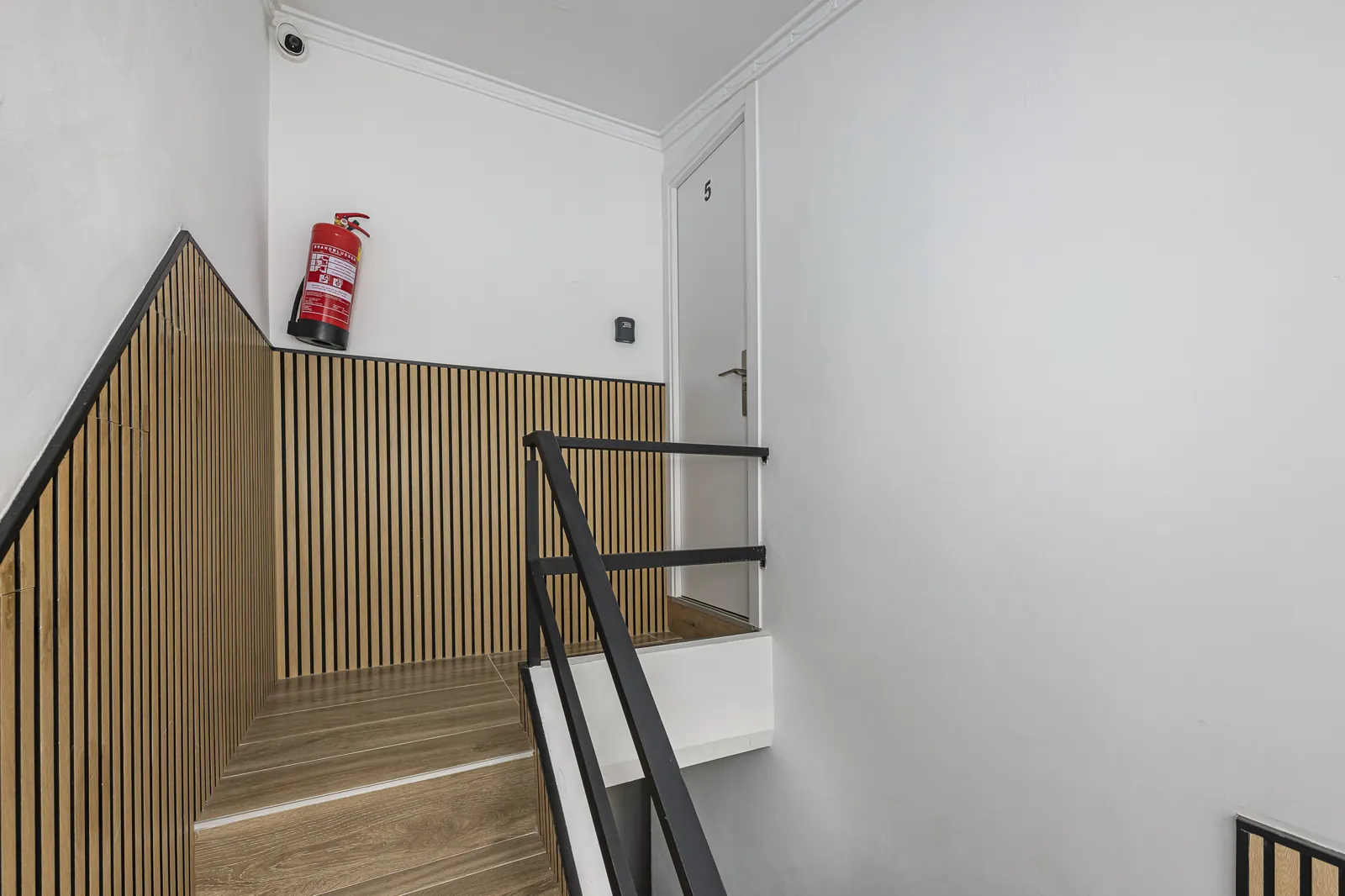 The oak stair to the top floor and the door of Room 5