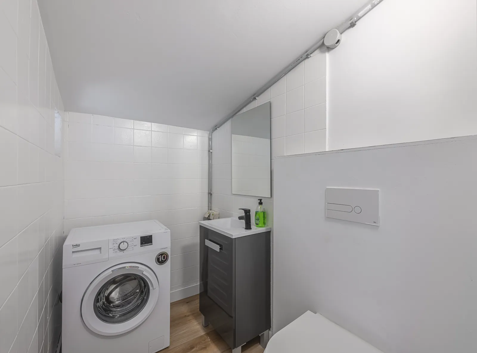 Room 5: the second WC under the eaves, with a washing machine and a small basin